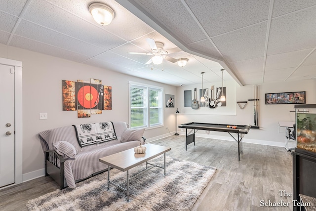 12150 Apple Cart Ln, Lowell, MI 49331 - living area with a paneled ceiling, wood finished floors, ceiling fan, baseboards, and a chandelier
