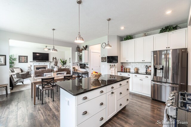 12150 Apple Cart Ln, Lowell, MI 49331 - kitchen featuring stainless steel refrigerator with ice dispenser, decorative backsplash, dark wood finished floors, white cabinets, and decorative light fixtures