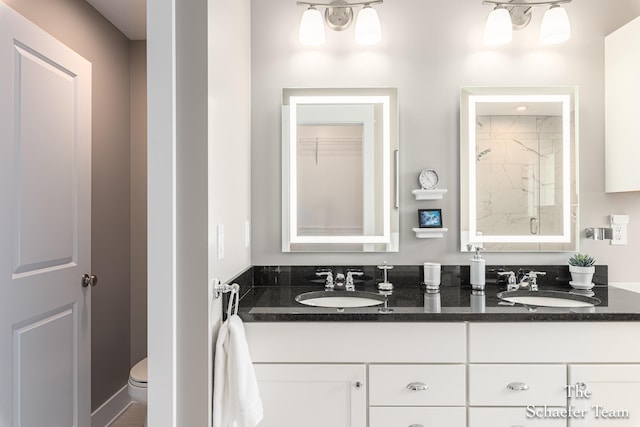 12150 Apple Cart Ln, Lowell, MI 49331 - bathroom with a shower with door, double vanity, and toilet
