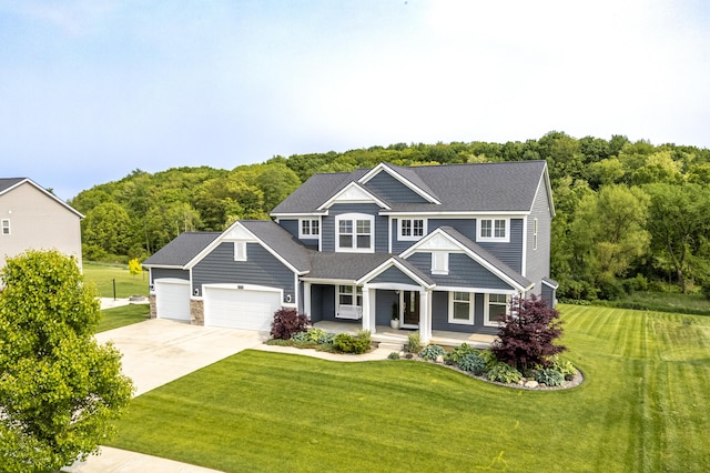 12150 Apple Cart Ln, Lowell, MI 49331 - view of front of property with a porch, driveway, a garage, and a front yard
