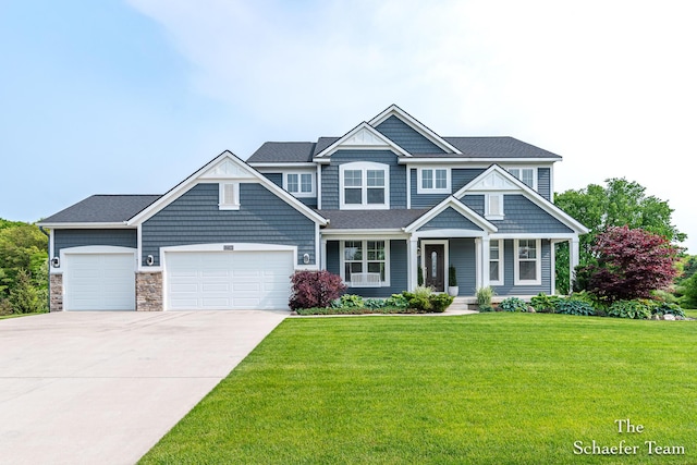 12150 Apple Cart Ln, Lowell, MI 49331 - view of front of home with an attached garage, driveway, a front lawn, a porch, and stone siding