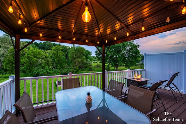 12150 Apple Cart Ln, Lowell, MI 49331 - wooden terrace with outdoor dining area, an outdoor fire pit, a gazebo, and a yard