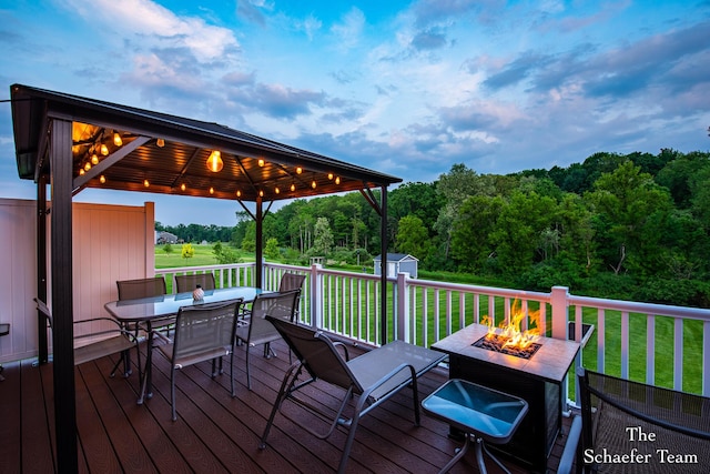 12150 Apple Cart Ln, Lowell, MI 49331 - wooden deck with a fire pit, a gazebo, outdoor dining space, and a lawn