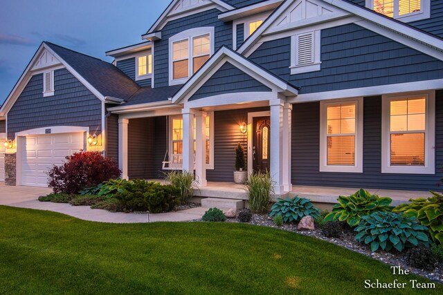 12150 Apple Cart Ln, Lowell, MI 49331 - craftsman house featuring a porch, an attached garage, driveway, and a front lawn