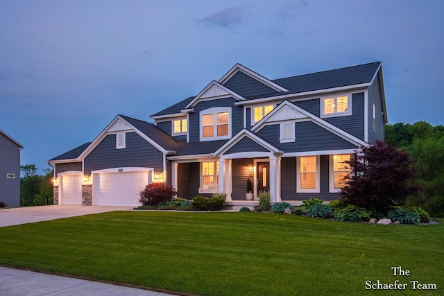12150 Apple Cart Ln, Lowell, MI 49331 - view of front of house with a porch, driveway, a front lawn, an attached garage, and stone siding
