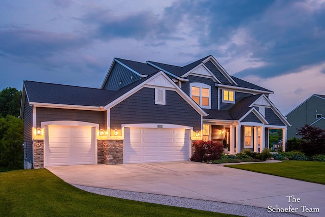 12150 Apple Cart Ln, Lowell, MI 49331 - craftsman house with an attached garage, driveway, a front yard, and stone siding