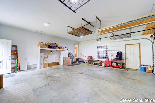 19151 Pine Grove Ct, Spring Lake, MI 49456 - garage featuring a garage door opener