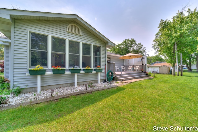 19151 Pine Grove Ct, Spring Lake, MI 49456 - view of home's exterior featuring a wooden deck and a lawn