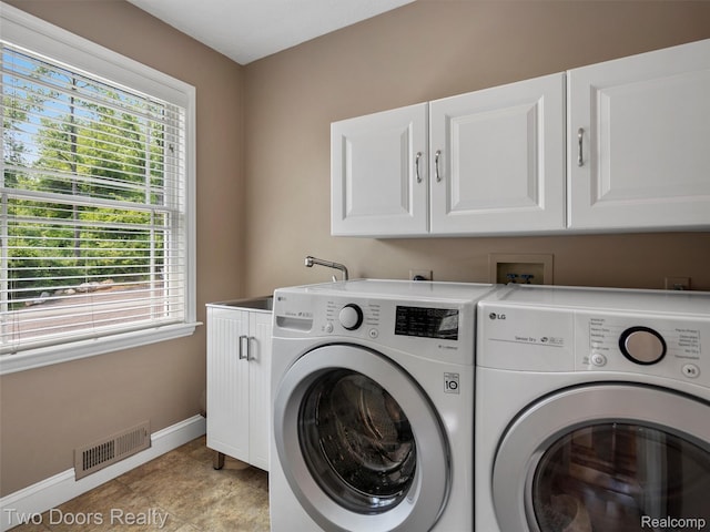 3040 Honey Bee Ln, Oxford, MI 48370 - washroom with cabinet space, separate washer and dryer, baseboards, and plenty of natural light