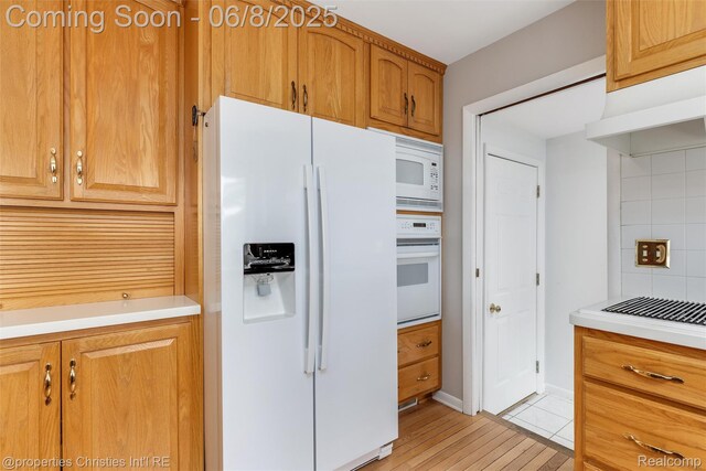 3379 Wormer Dr, Waterford, MI 48329 - kitchen with white appliances, tasteful backsplash, light countertops, and light wood finished floors