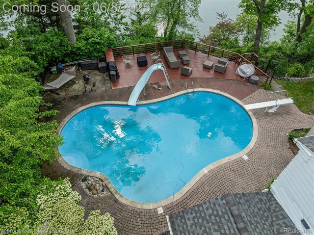 3379 Wormer Dr, Waterford, MI 48329 - view of pool with a water slide, a diving board, outdoor lounge area, a patio, and a deck