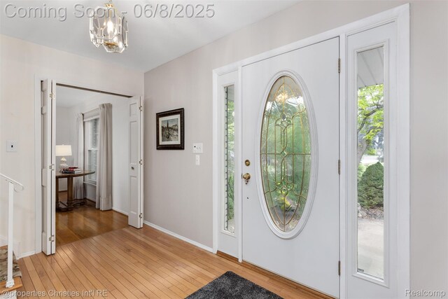 3379 Wormer Dr, Waterford, MI 48329 - foyer with light wood finished floors, a chandelier, and baseboards