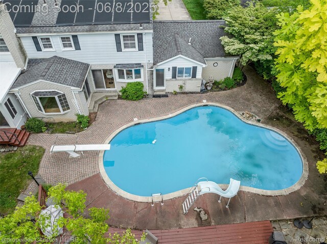 3379 Wormer Dr, Waterford, MI 48329 - swimming pool featuring a diving board and a patio