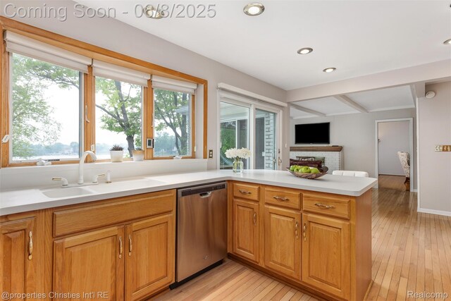 3379 Wormer Dr, Waterford, MI 48329 - kitchen with dishwasher, a sink, plenty of natural light, light wood finished floors, and beamed ceiling