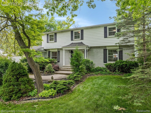 3379 Wormer Dr, Waterford, MI 48329 - view of front of home with brick siding and a front yard