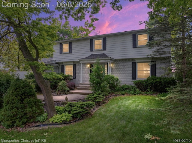 3379 Wormer Dr, Waterford, MI 48329 - view of front of home with brick siding and a lawn