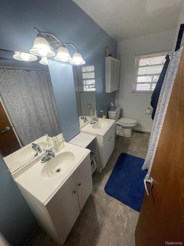 8415 Cappy Ln, Swartz Creek, MI 48473 - full bath featuring two vanities and toilet