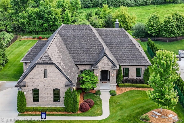 1641 Traceky, Rochester Hills, MI 48306 - view of front of home featuring brick siding, a front yard, and a shingled roof