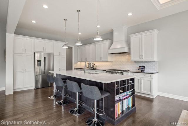 1641 Traceky, Rochester Hills, MI 48306 - kitchen with stainless steel refrigerator with ice dispenser, custom range hood, backsplash, a kitchen island with sink, and white cabinets