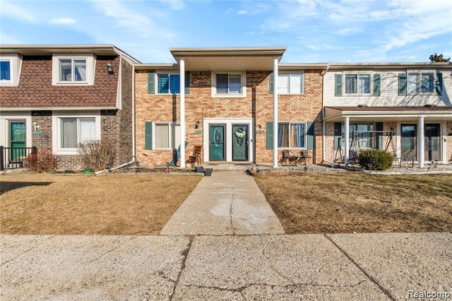 38132 Jamestown Dr, Sterling Heights, MI 48312 - townhome / multi-family property with brick siding and a front lawn