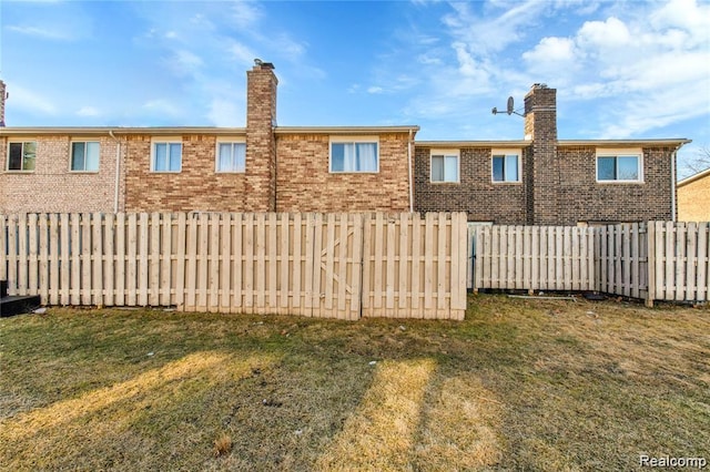 38132 Jamestown Dr, Sterling Heights, MI 48312 - back of house with a chimney and brick siding