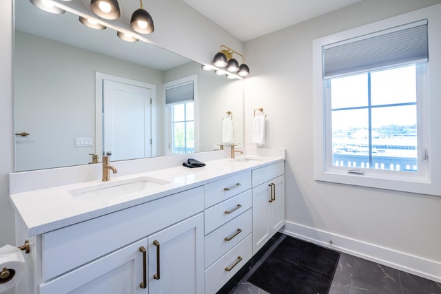917 Harbor Dr E, Saint Joseph, MI 49085 - bathroom with double vanity, baseboards, and marble finish floors