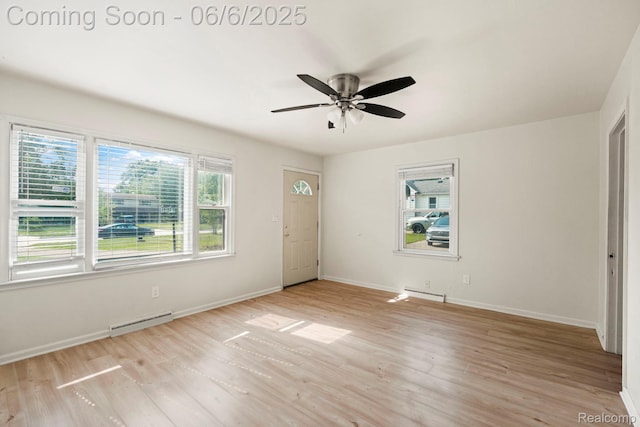 23808 Beierman Ave, Warren, MI 48091 - foyer entrance with light wood finished floors, baseboards, a ceiling fan, and a baseboard heating unit