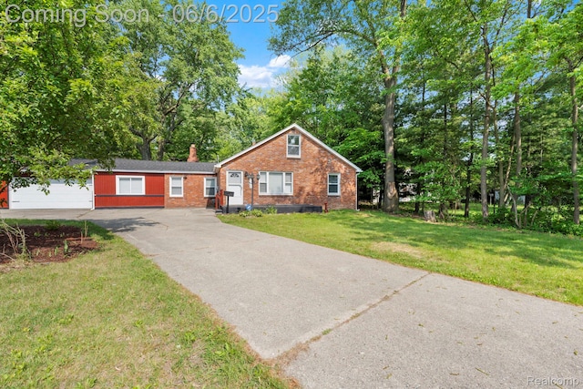 23808 Beierman Ave, Warren, MI 48091 - view of front of property with brick siding, driveway, a front lawn, a chimney, and view of wooded area