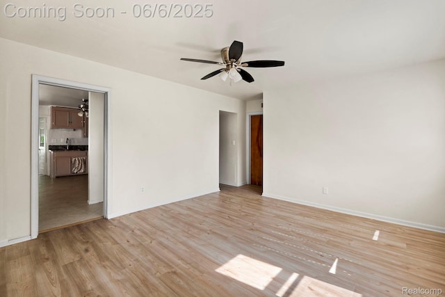 23808 Beierman Ave, Warren, MI 48091 - spare room featuring light wood-type flooring, a ceiling fan, baseboards, and a sink