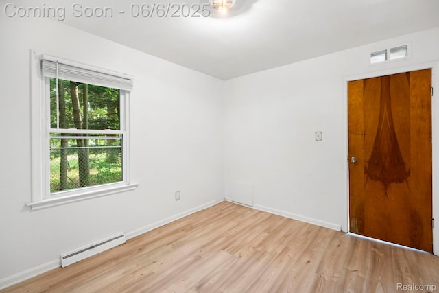 23808 Beierman Ave, Warren, MI 48091 - empty room with baseboard heating, light wood finished floors, and baseboards