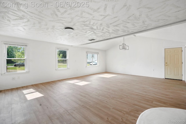 23808 Beierman Ave, Warren, MI 48091 - empty room featuring lofted ceiling, healthy amount of natural light, light wood finished floors, and baseboards
