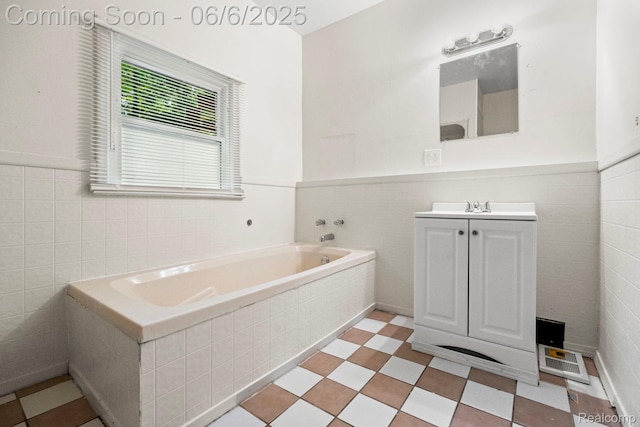 23808 Beierman Ave, Warren, MI 48091 - bathroom with tile walls, vanity, a garden tub, and a wainscoted wall
