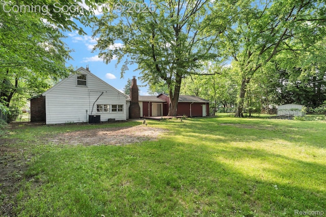 23808 Beierman Ave, Warren, MI 48091 - view of green lawn featuring a garage and central AC