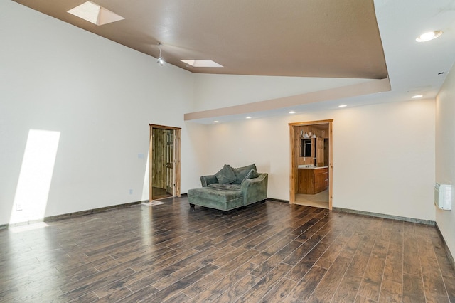 6997 W Woodlea Rd, Oscoda, MI 48750 - sitting room featuring a skylight, wood finished floors, recessed lighting, lofted ceiling, and baseboards