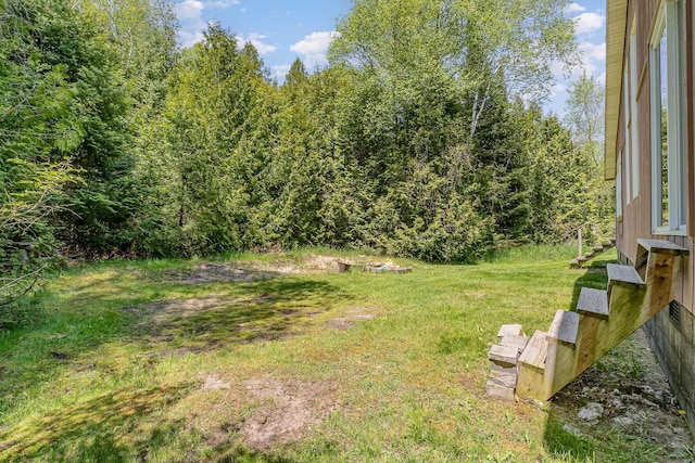 6997 W Woodlea Rd, Oscoda, MI 48750 - view of grassy yard featuring a view of trees