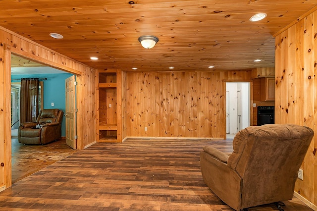 6997 W Woodlea Rd, Oscoda, MI 48750 - sitting room featuring hardwood / wood-style flooring, recessed lighting, wood ceiling, and wood walls