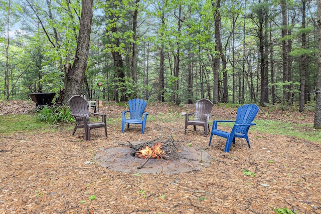 1518 White Pine Ct, Twin Lake, MI 49457 - view of yard with a fire pit and a wooded view