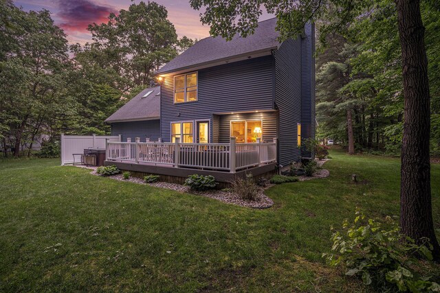 1518 White Pine Ct, Twin Lake, MI 49457 - back of house at dusk featuring a wooden deck, a chimney, a lawn, and roof with shingles