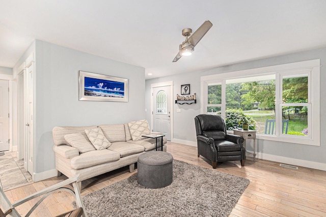 1518 White Pine Ct, Twin Lake, MI 49457 - living area with ceiling fan, baseboards, and light wood finished floors