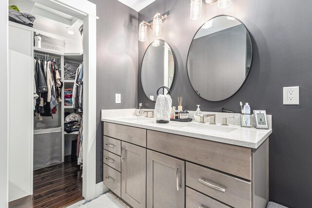 1518 White Pine Ct, Twin Lake, MI 49457 - full bathroom featuring double vanity, a spacious closet, and wood finished floors