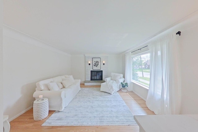 2113 12th St, Wyandotte, MI 48192 - living area with a fireplace, light wood finished floors, and baseboards