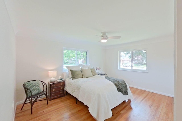2113 12th St, Wyandotte, MI 48192 - bedroom with light wood-style flooring, baseboards, and ceiling fan