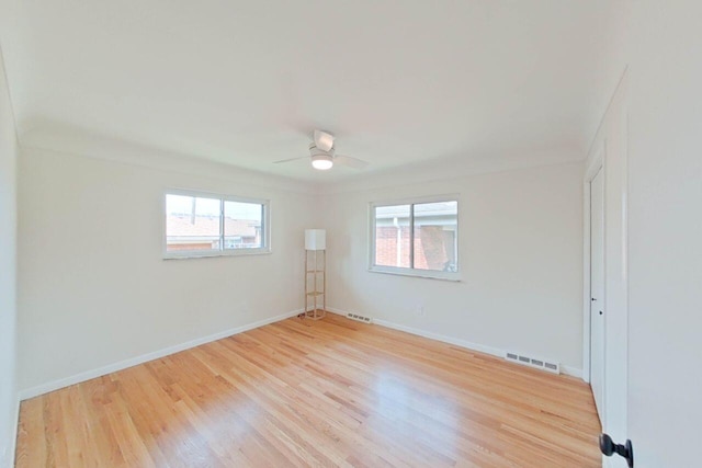 2113 12th St, Wyandotte, MI 48192 - spare room with light wood-type flooring, a ceiling fan, and baseboards