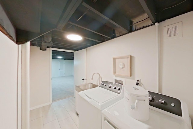 2113 12th St, Wyandotte, MI 48192 - laundry room with washer and clothes dryer and light tile patterned flooring