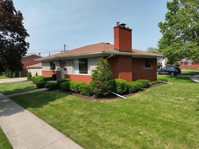 2113 12th St, Wyandotte, MI 48192 - view of home's exterior with brick siding, a chimney, and a lawn