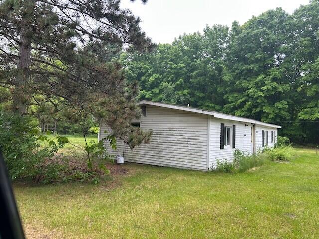 11312 Fitzgerald Ave, Grant, MI 49327 - view of property exterior with a lawn