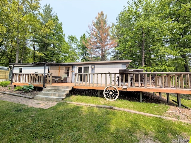 3730 Pinelands Rd, Gladwin, MI 48624 - rear view of house with a lawn and a deck