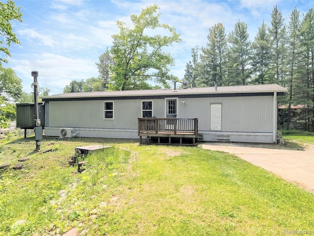 3730 Pinelands Rd, Gladwin, MI 48624 - back of property with a deck and a lawn