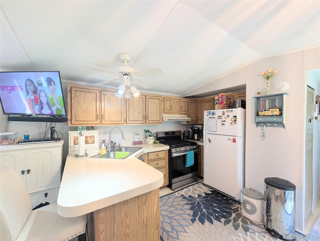 3730 Pinelands Rd, Gladwin, MI 48624 - kitchen with freestanding refrigerator, stainless steel gas range, a sink, a peninsula, and vaulted ceiling