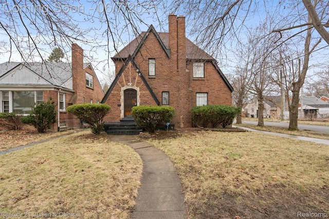 15915 Vaughan St, Detroit, MI 48223 - english style home featuring brick siding, a front lawn, and a chimney